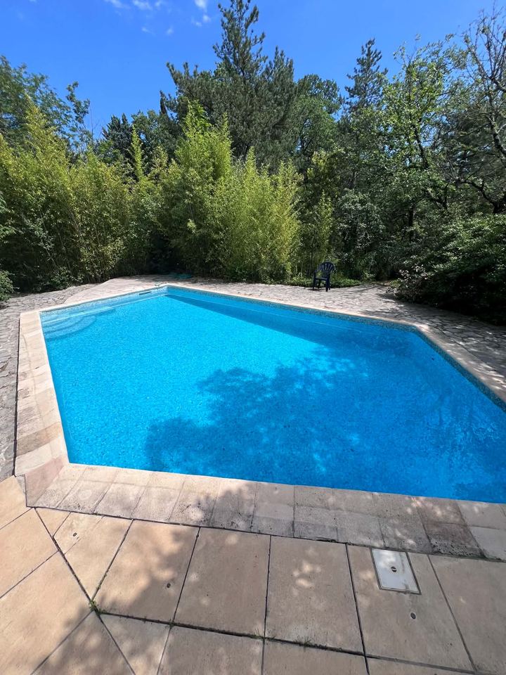 La même piscine avec une eau bleue et claire après traitement